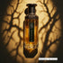 Amjad Honour gold and black perfume bottle branded by Faan Perfumes on a branch like background featured on 'ArabiaScents'