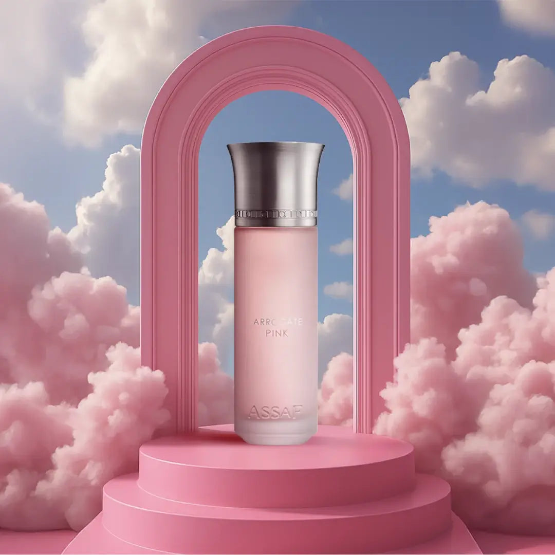 'Pink Arrogate' perfume bottle with silver cap on a pink platform against a cloudy sky background with Assaf branding