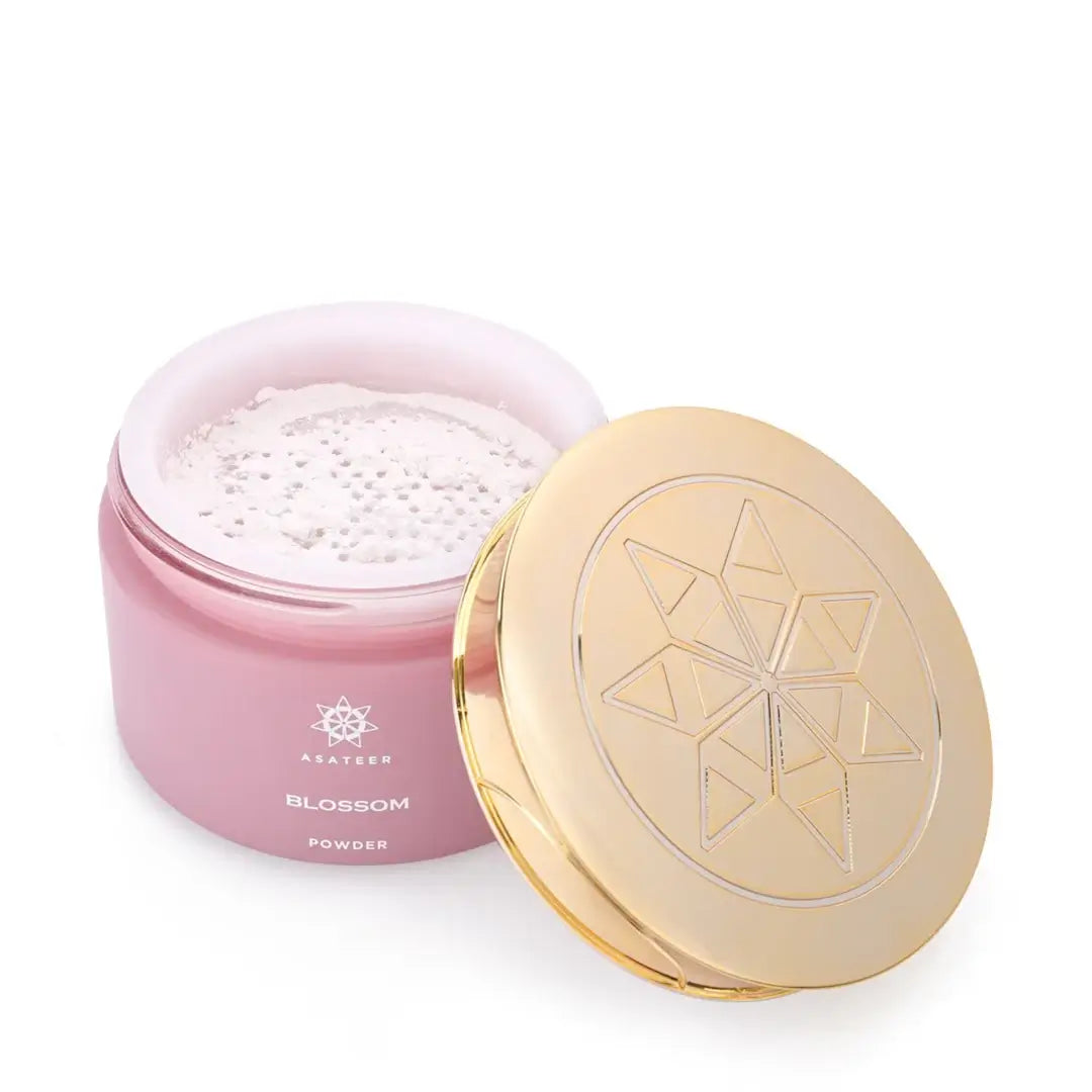 'Blossom Scented Body Powder' by Asateer pink container with a gold lid on a white background