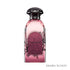 Decorative Pink perfume bottle with  'Charming' label branded Dkhoon Emirates on a white background featured by ArabiaScents