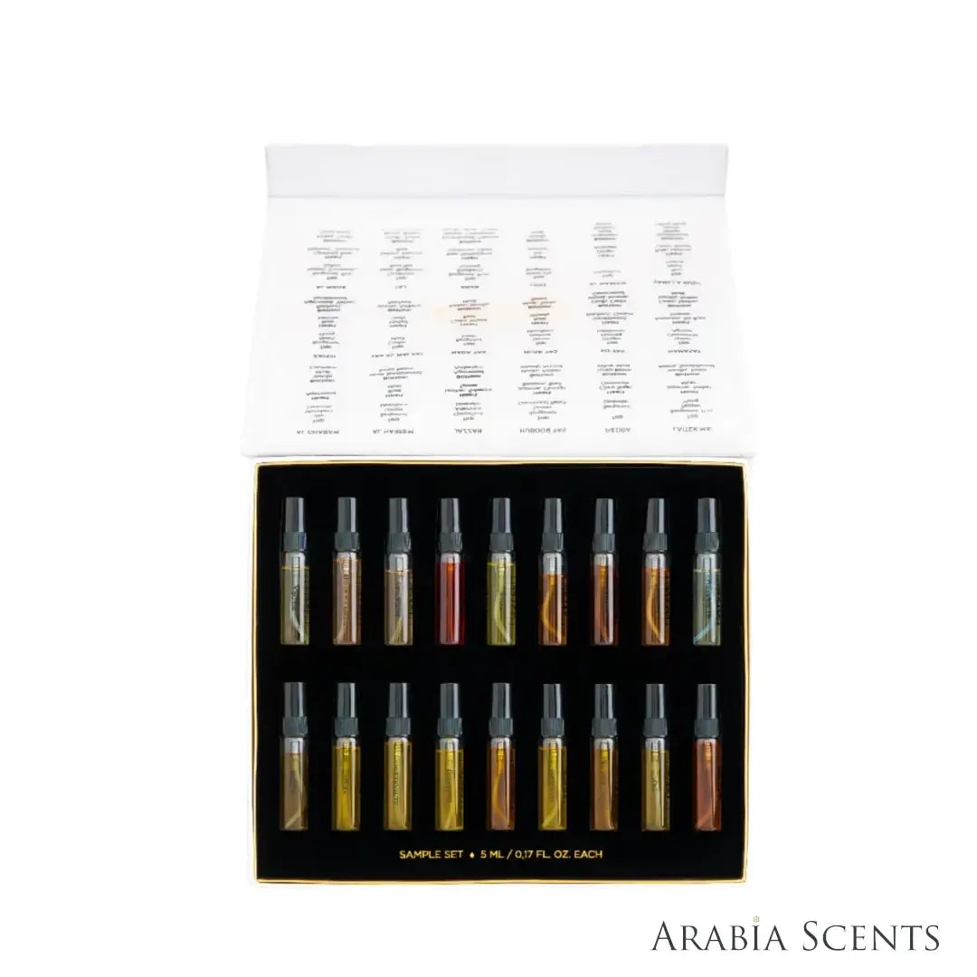 Yas Discovery fragrance sample set box displaying 18 small glass spray vials with amber and red liquids, set against a white background featured on 'ArabiaScents'