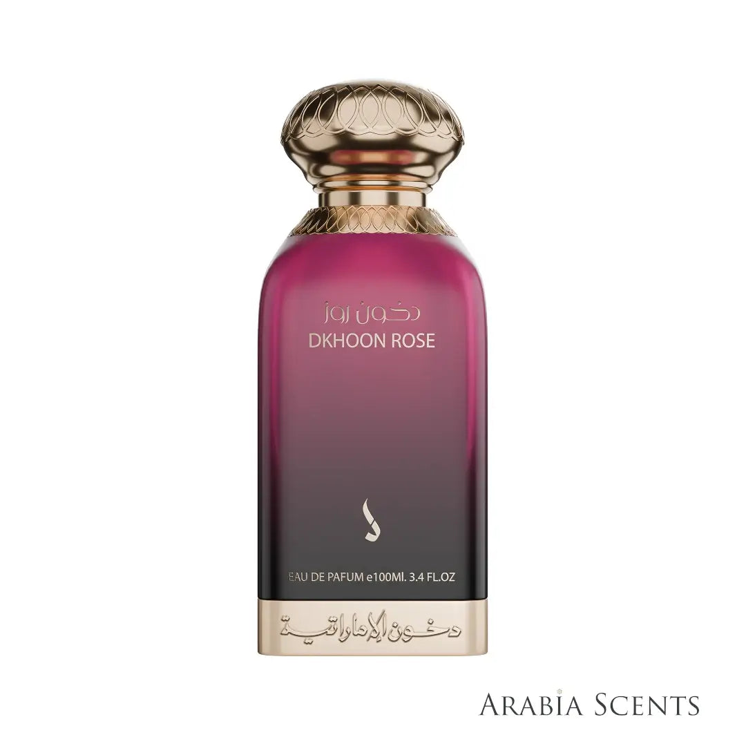'Dkhoon Rose' Perfume bottle with gold cap and dark pink body branded Dkhoom Emirates on a white background, featured on 'ARABIASCENTS'