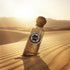 Emarati Imperial perfume bottle with Gissah brand on a sand dune with a sunset in the background