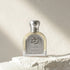 'Future Oud' Perfume bottle with silver cap and label on a textured surface branded Emirates Pride
