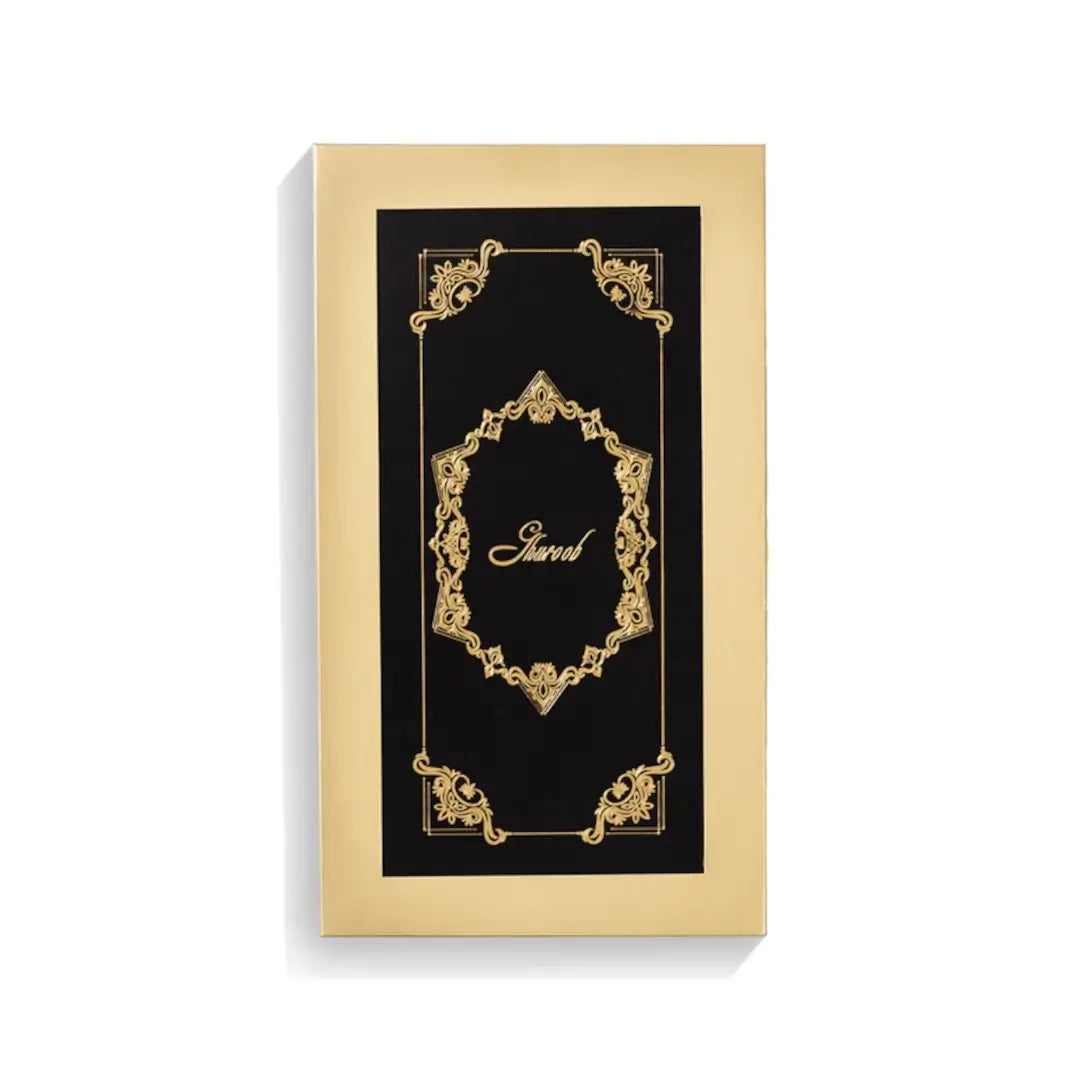 'Ghuroob' perfume Gold and black decorative box with intricate designs on a white background branded Junaid