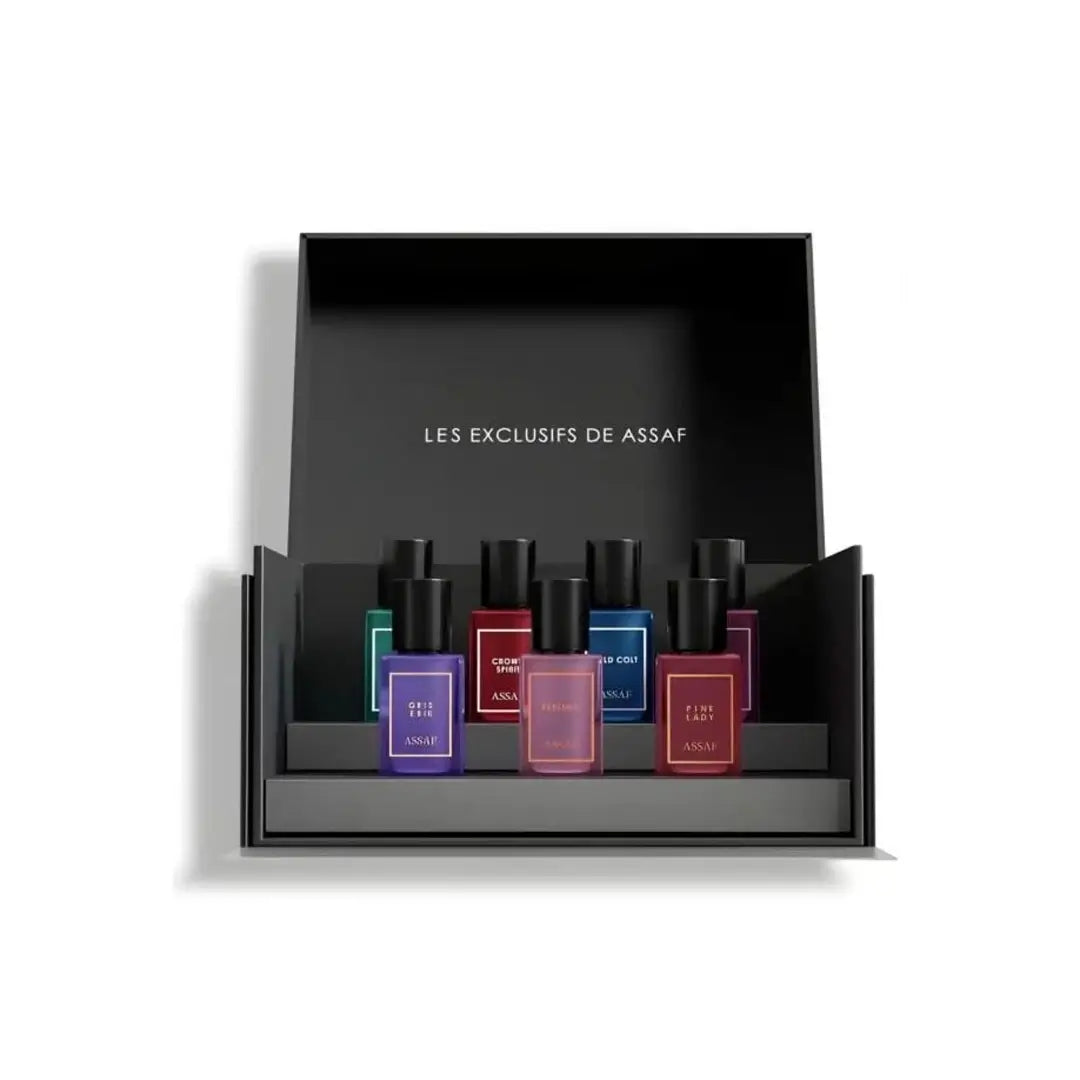Set of small perfume bottles in a black display box with 'LES EXCLUSIFS DE ASSAF' branding.
