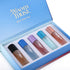 Set of five small bottles with different colors and names in a 'Ayaam Musk' branded box