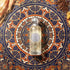 'Omani Imperial' Perfume bottle on a decorative patterned surface with coffee beans and wood by Gissah