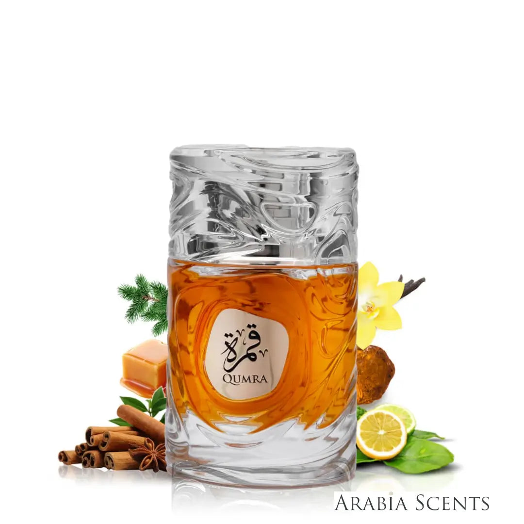 'Qumra' perfume bottle surrounded by spices and fruits on a white background branded Le Bonheur featured on 'ArabiaScents'