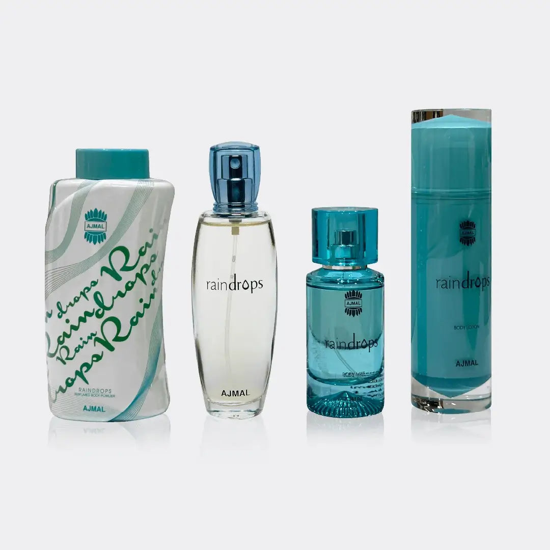 Four Ajmal Raindrops perfume bottles of different sizes on a white background