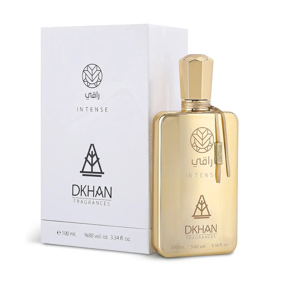'Raqi Intense' gold perfume bottle and packaging with 'DKHAN Fragrances' branding on a white background