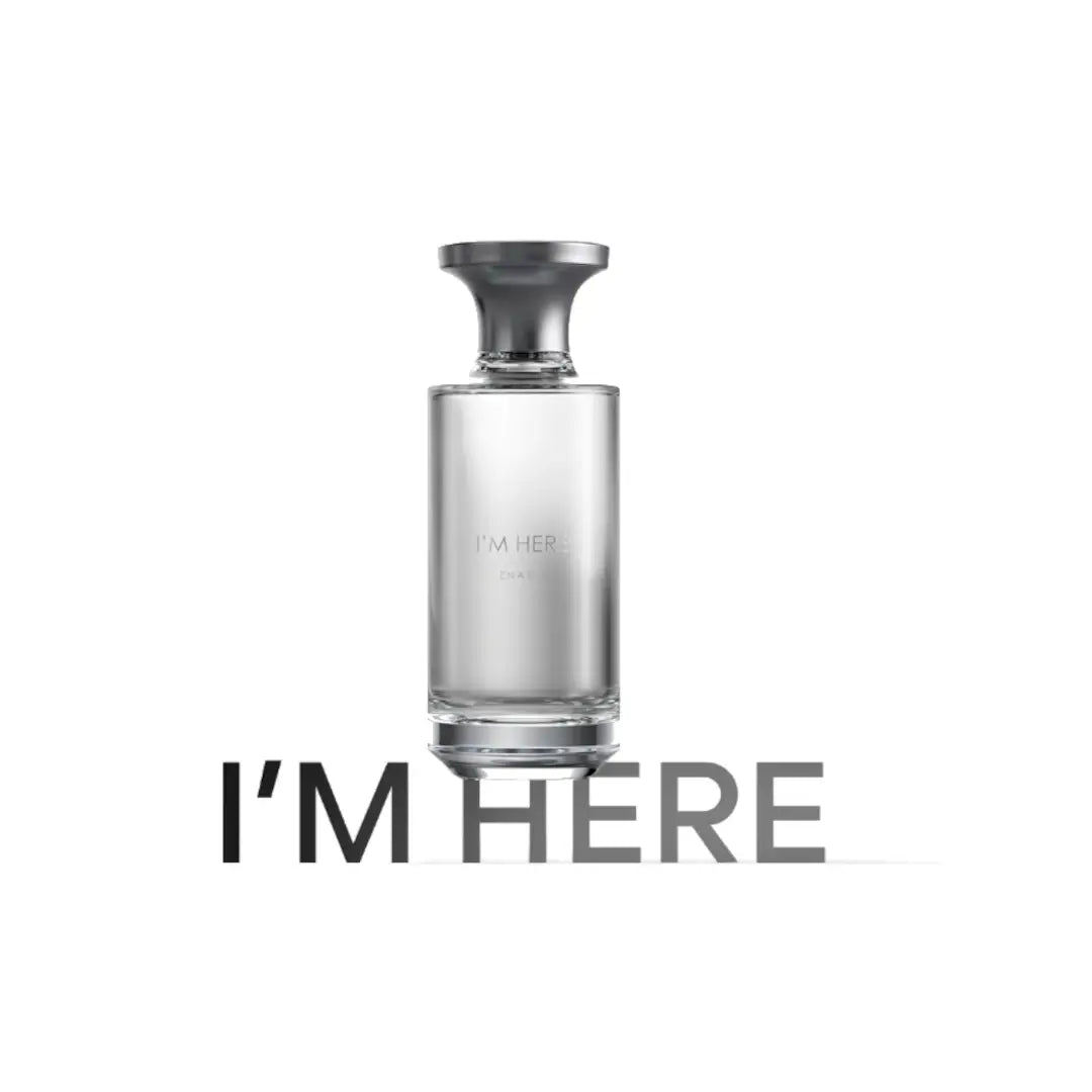 'I'M HERE' Clear perfume bottle with black cap on a white background, featuring the brand Assaf.