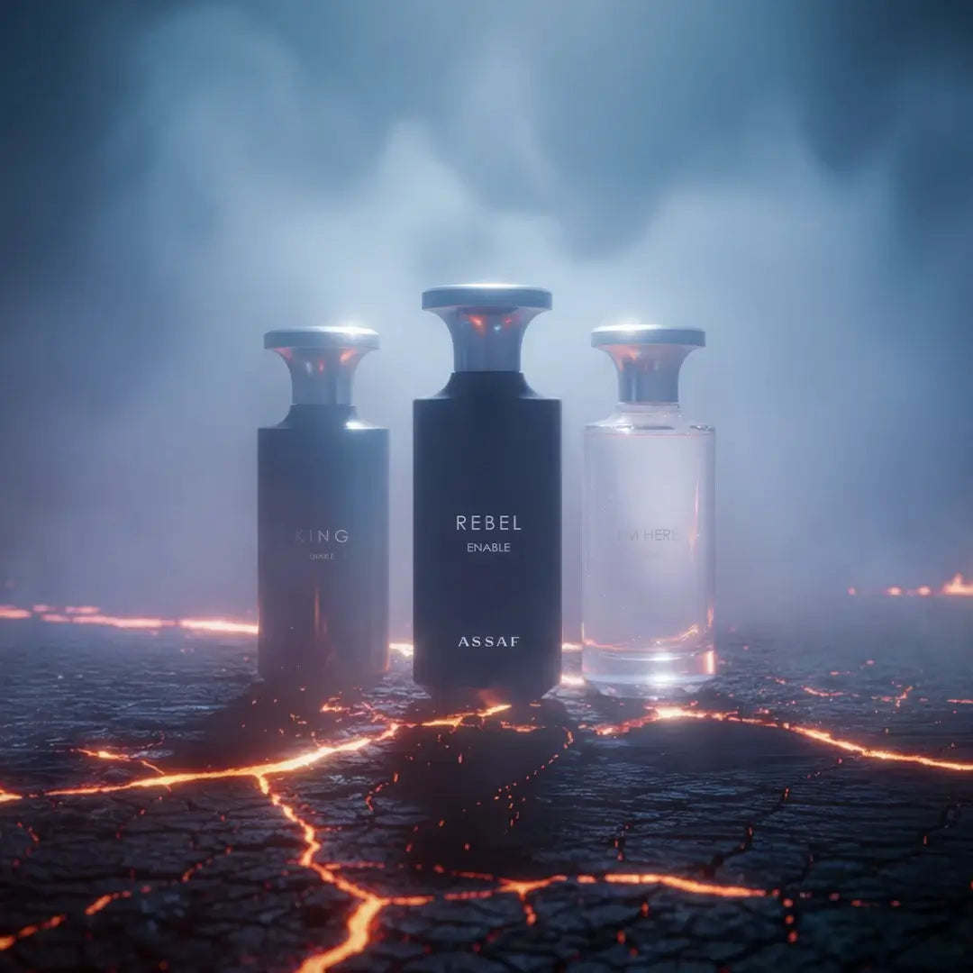 Three perfume bottles labeled 'King Enable', 'Rebel Enable', and 'I'M Here' by Assaf on a dark, smoky background.