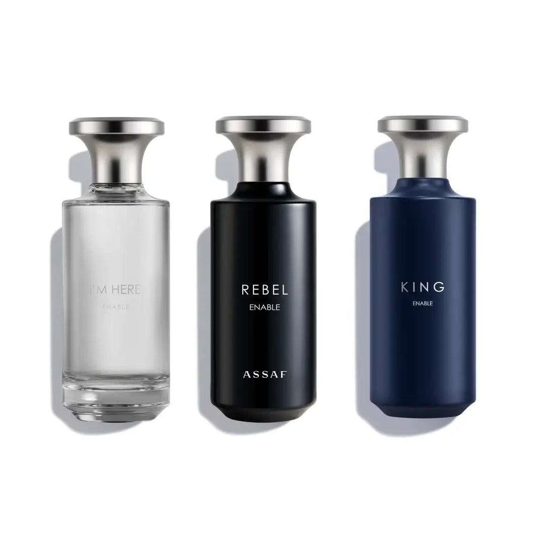 Three perfume bottles labeled 'I'm Here', 'Rebel Enable' by Assaf, and 'King Enable' on a white background.