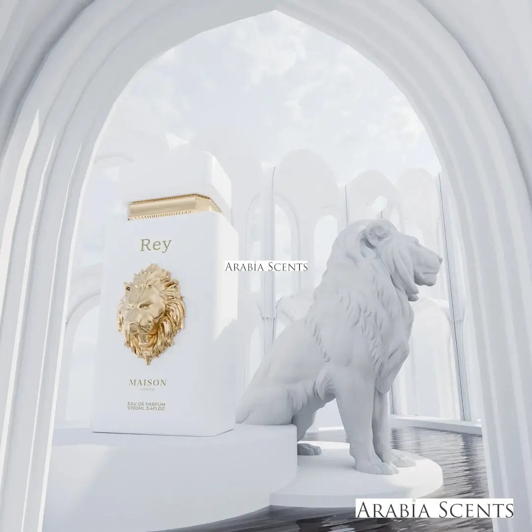 Maison Asrar 'Rey' perfume bottle with a lion statue in a white architectural setting featured by ArabiaScents