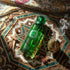 Green 'Saudi Imperial' perfume bottle on a decorative surface with intricate patterns with Gissah branding
