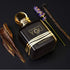 'Stronger With You Oud' Perfume bottle with gold accents on a dark background, featuring vanilla beans and lavender branded Emporio Armani