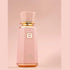 Sweet Paradise by French Avenue Pink perfume bottle with gold accents on a matching pink background