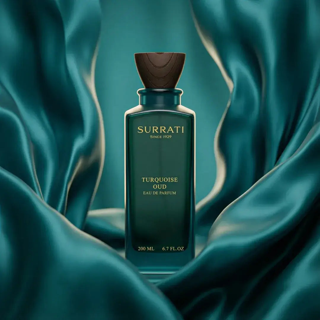 Surrati Turquoise Oud perfume bottle on a teal fabric background