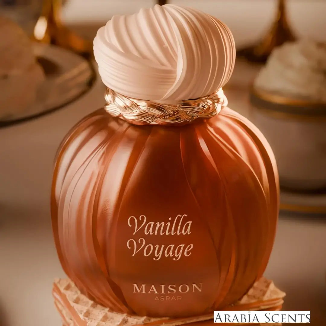 Pumpkin-shaped perfume bottle labeled 'Vanilla Voyage' by MAISON ASRAR featured by ARABIA SCENTS on a blurred background. 