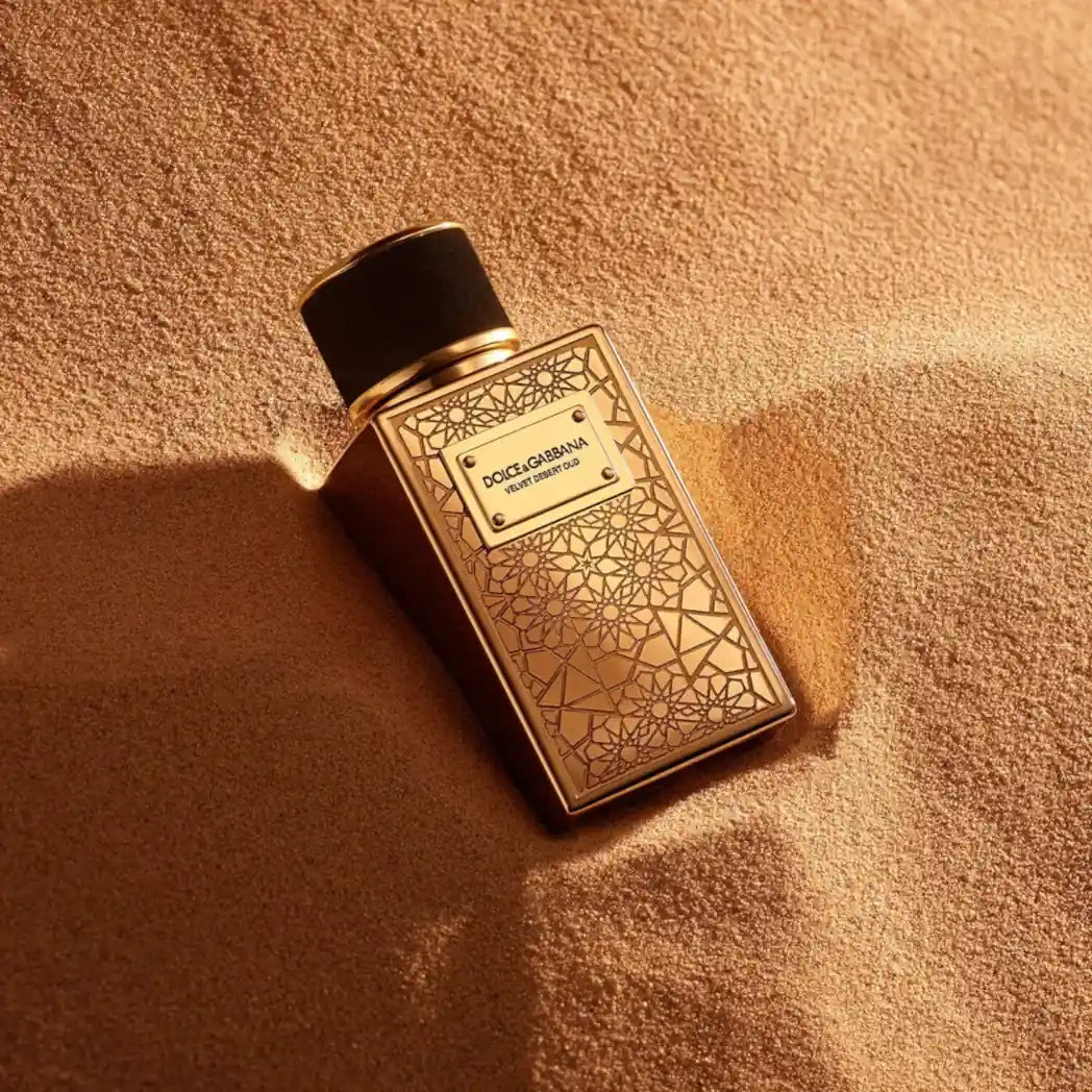 Dolce & Gabbana Velvet Desert Oud Ramadan Edition perfume bottle on a textured beige surface