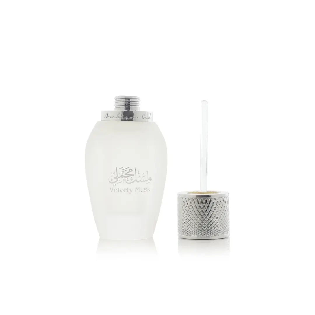 White 'Velvety Musk'  bottle with silver lid and decorative container on a white background branded Arabian Oud