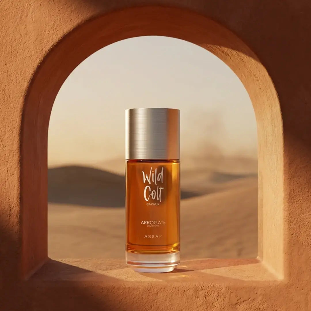 Perfume bottle labeled 'Wild Colt Bakhur' by Arrogante Assaf in a desert setting